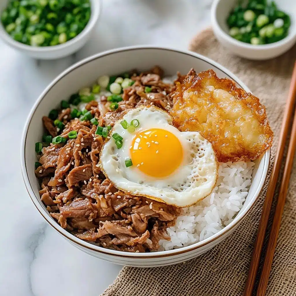 Japanese Beef & Rice Bowls Gyudon, gyudon recipe, Japanese beef bowl, quick Japanese dinner, savory beef rice bowl A bowl with three layers is shown on a white marbled surface. The bottom layer is white rice, soft and fluffy. The middle layer is small pieces of brown cooked meat mixed with translucent cooked onions and small green spring onion pieces, placed over the rice. The top layer is a fried egg with a bright yellow yolk and slightly crispy white edges, sprinkled with small white sesame seeds, sitting on the right side of the meat. Nearby, there is a small white bowl with green chopped spring onions, wooden chopsticks resting on a white ceramic spoon, and a larger white bowl with more of the cooked meat and onions visible inside. The setup is on a rough burlap fabric.