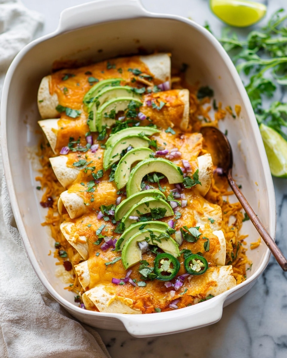 The dish shows a white baking dish filled with six rolled enchiladas placed side by side. The enchiladas have a soft, golden-brown tortilla layer on the outside, topped with a melted orange and white cheese layer that looks gooey and bubbly. On top of each enchilada are several thin, bright green avocado slices, evenly spread in a slight curve. Scattered around and on top are small pieces of purple chopped onion and thin slices of fresh green jalapeño. The background is a white marbled texture with some blurred green herbs nearby, creating a fresh look. The photo taken with an iphone --ar 4:5 --v 7